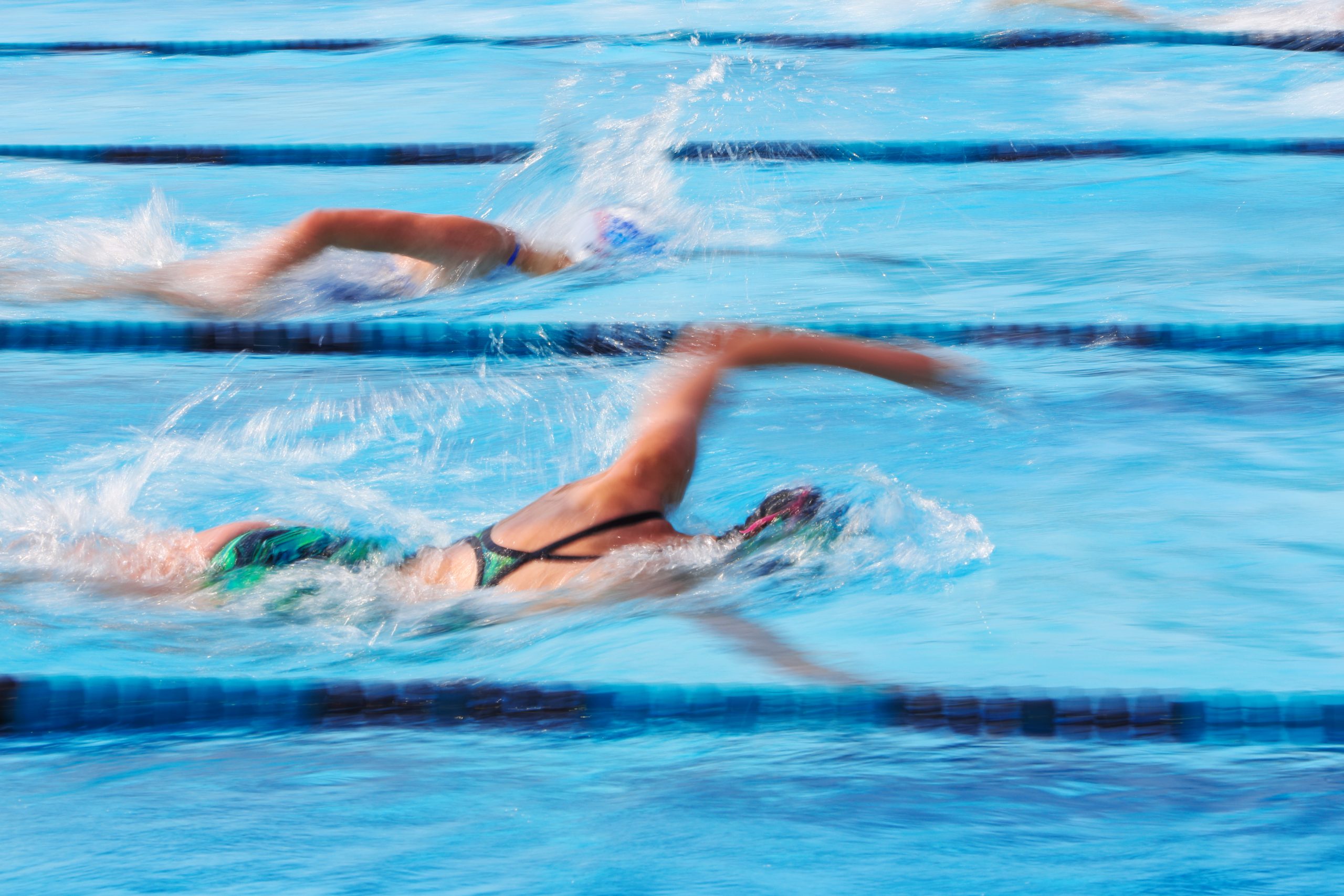 swimmer in water arm raised mid swim