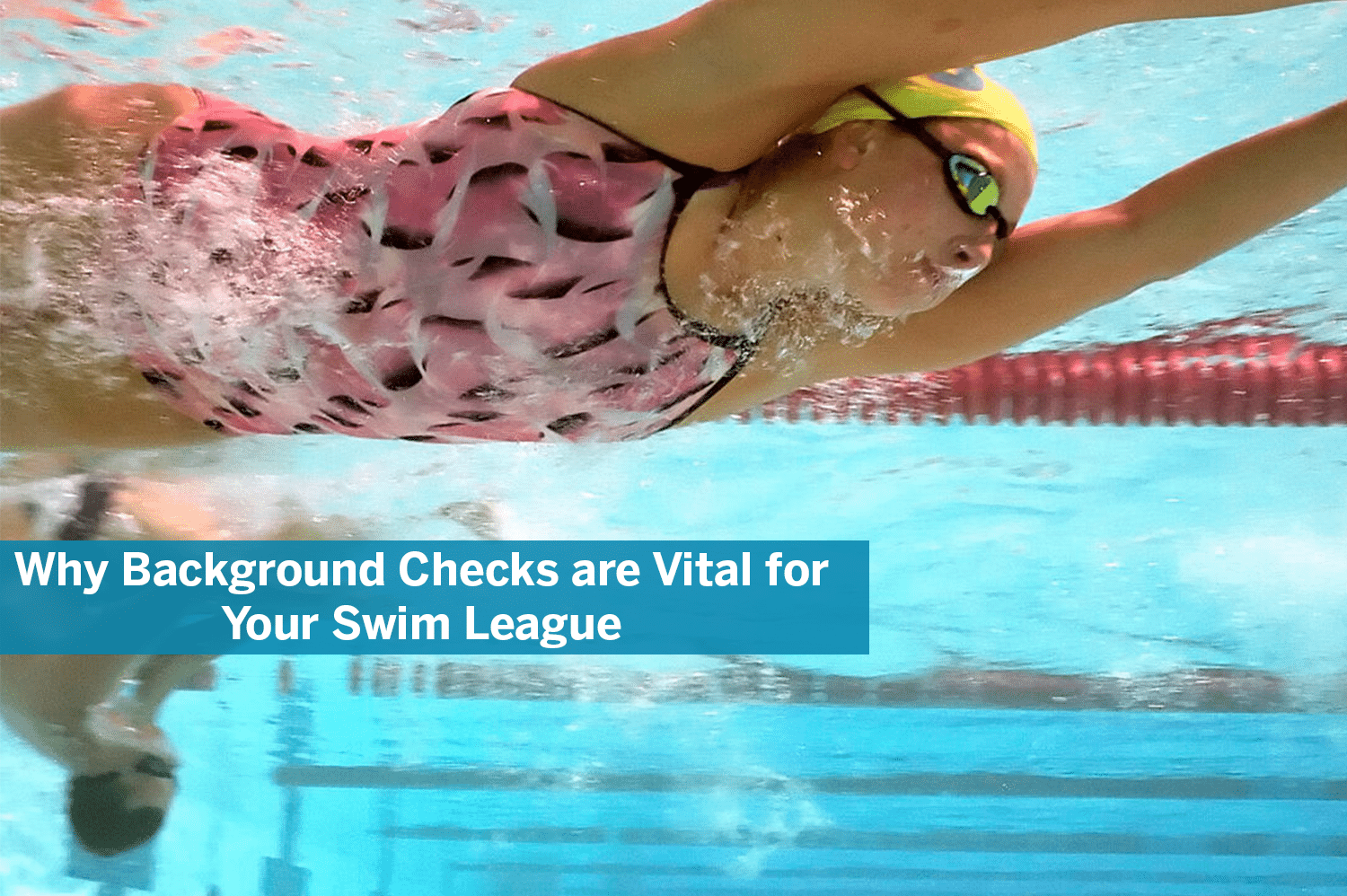 A young girl with a pink bathing suit, yellow cap, and black goggles, swimming under water for her swim league.