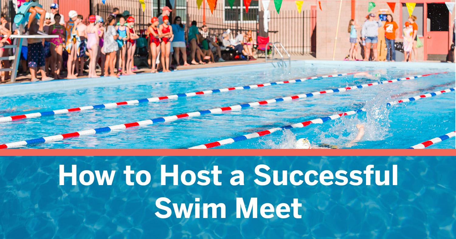 A kid swimming in an outdoor swim meet with his teammates cheering him on.